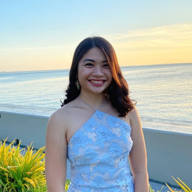 A woman with dark hair and a light blue dress