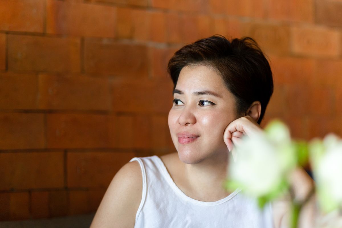 Smiling Asian woman with short hair.