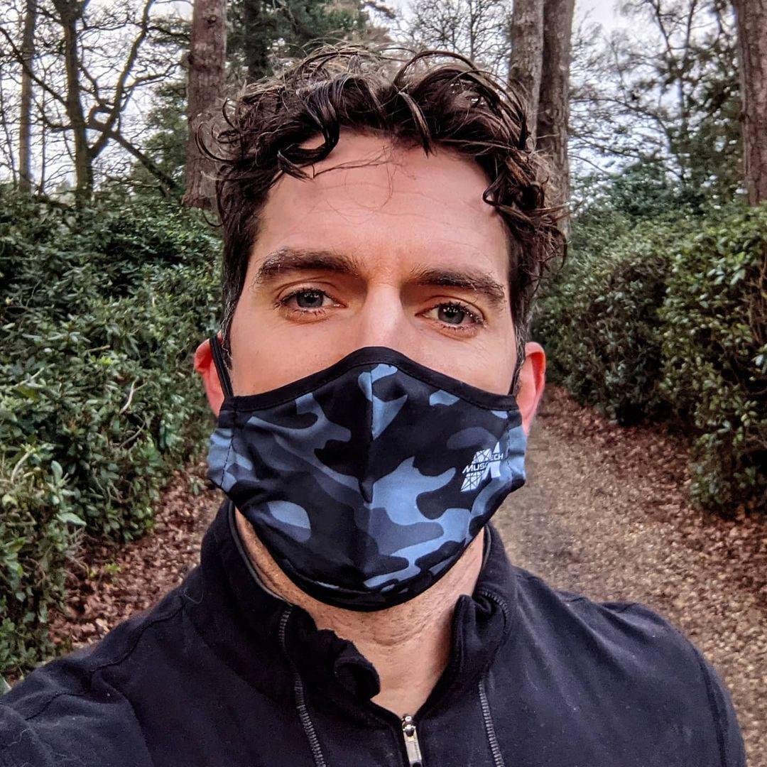 Henry Cavill wearing a face mask in the woods