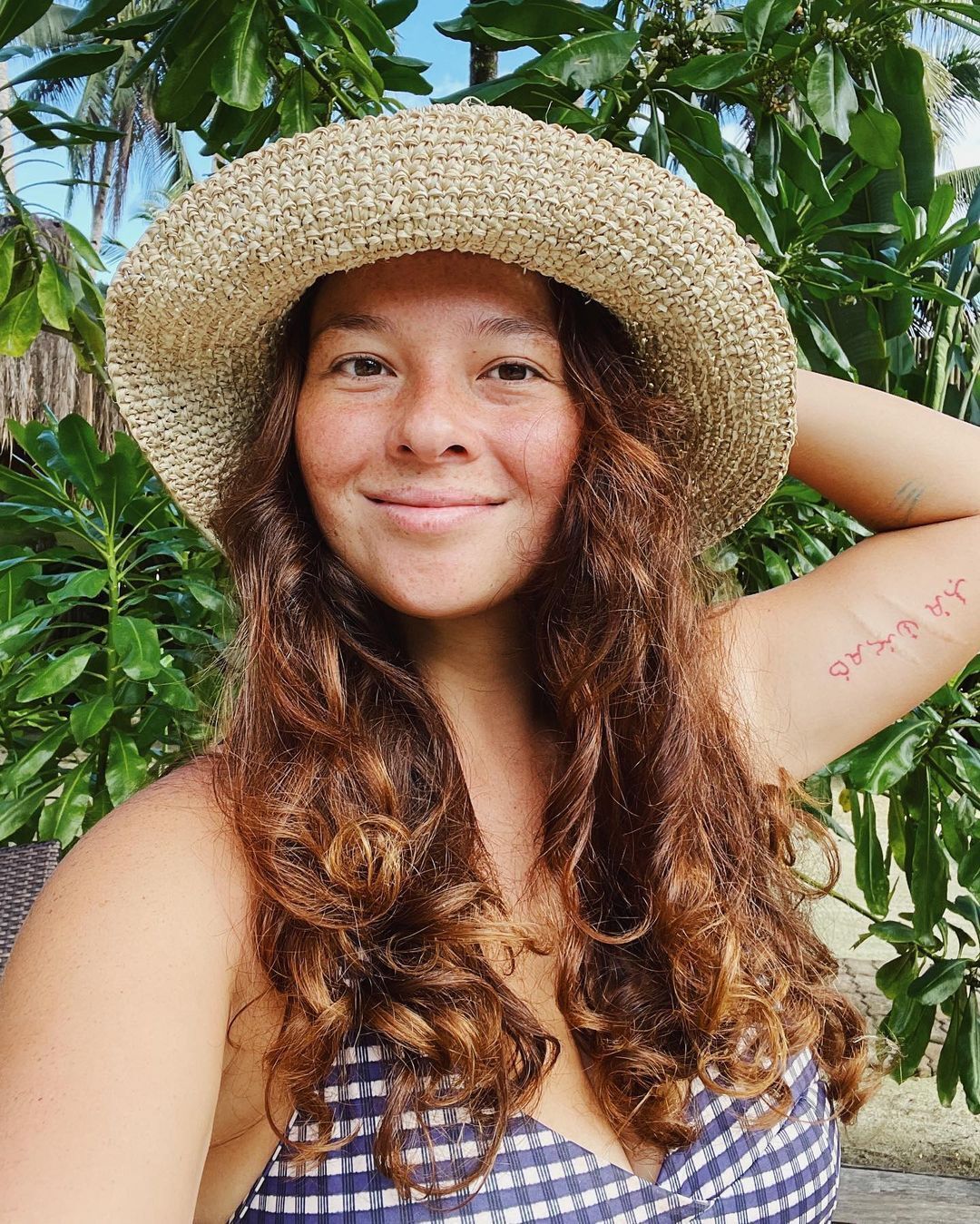 Asian woman with brown, soft curls.