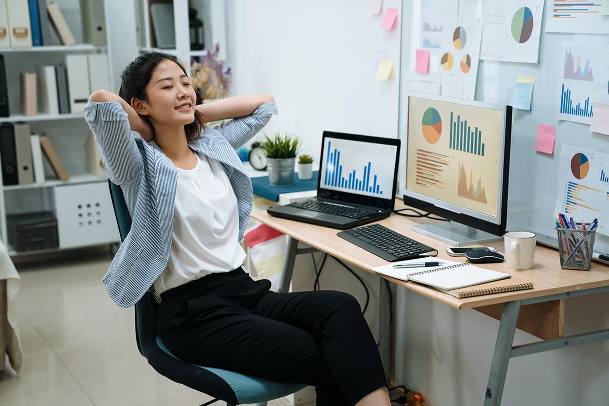 Asian woman leaning back in office 