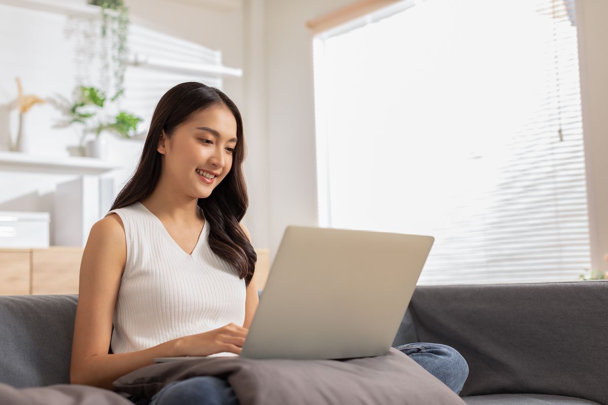 Asian woman reviewing something on her computer