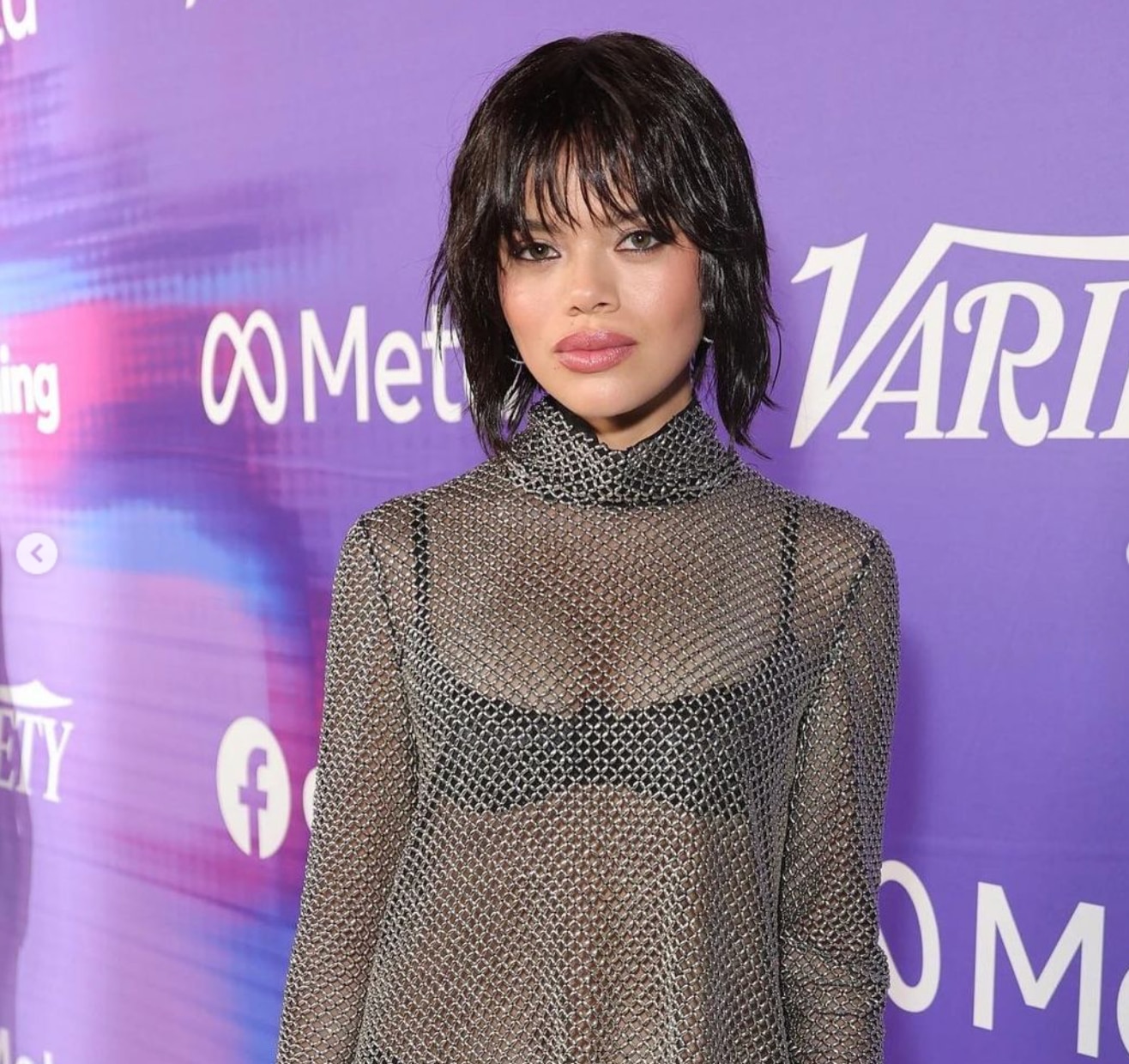 Asian woman with short hair and chain mail top