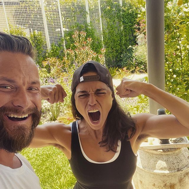 A selfie of a man and Michelle Rodriguez in an outdoor setting. 