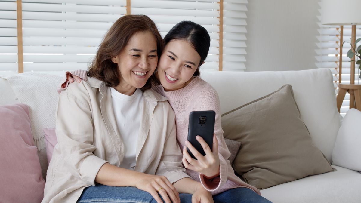 Asian mother and daughter smiling for a selfie