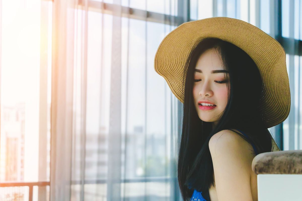 Asian woman wearing a straw hat