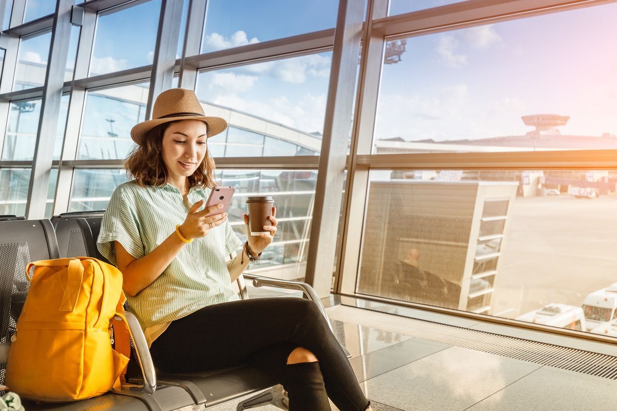 Asian woman at the airport ready for vacation