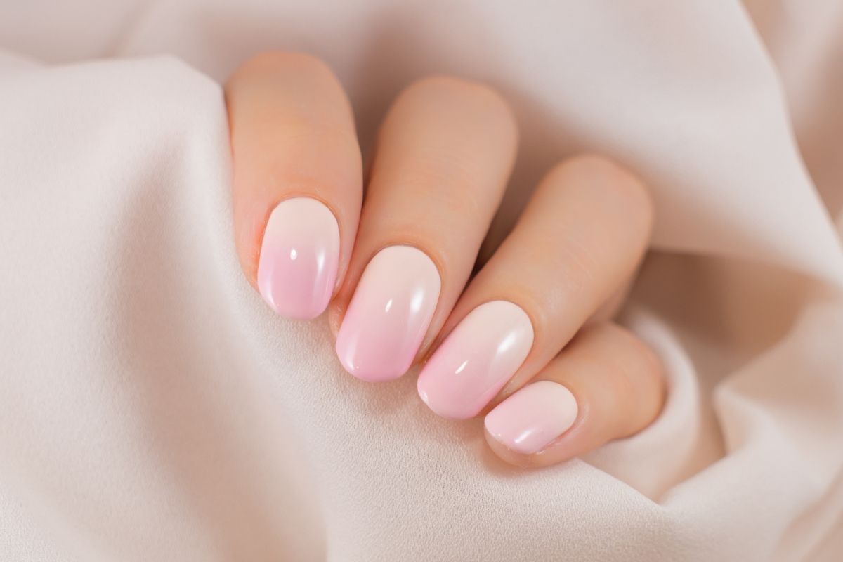 màu nail đẹp 2023 ombre trắng hồng trên nền vải màu trắng
