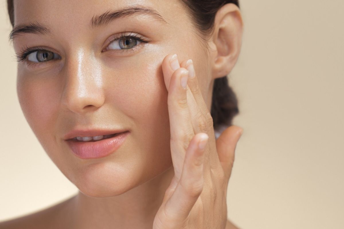 thải độc da mặt các cách thải độc da sử dụng hoạt chất chống oxy hóa cô gái nhìn vào ống kính tay chạm vào má bên trái