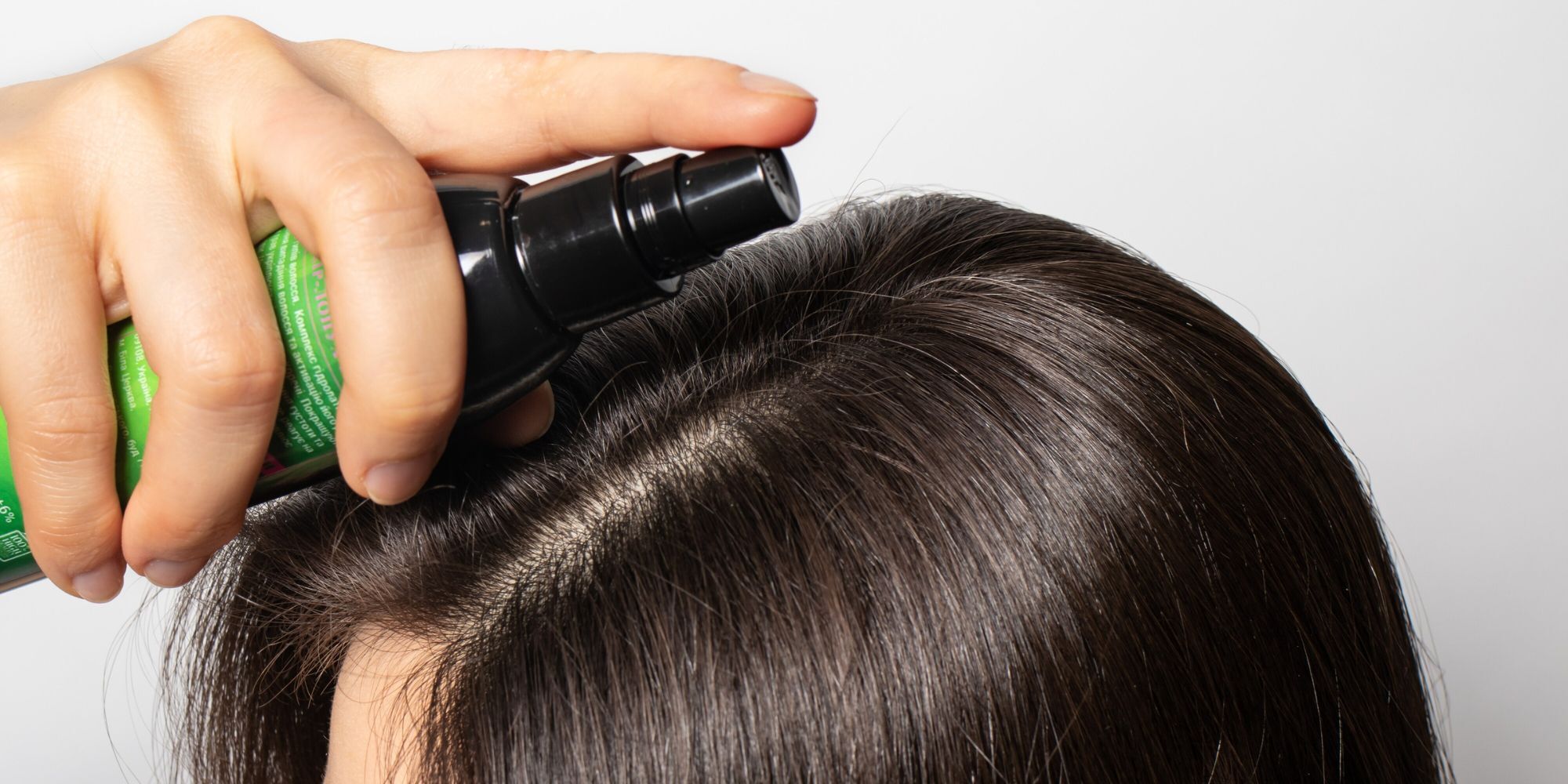 wanita menyemprotkan hair tonic