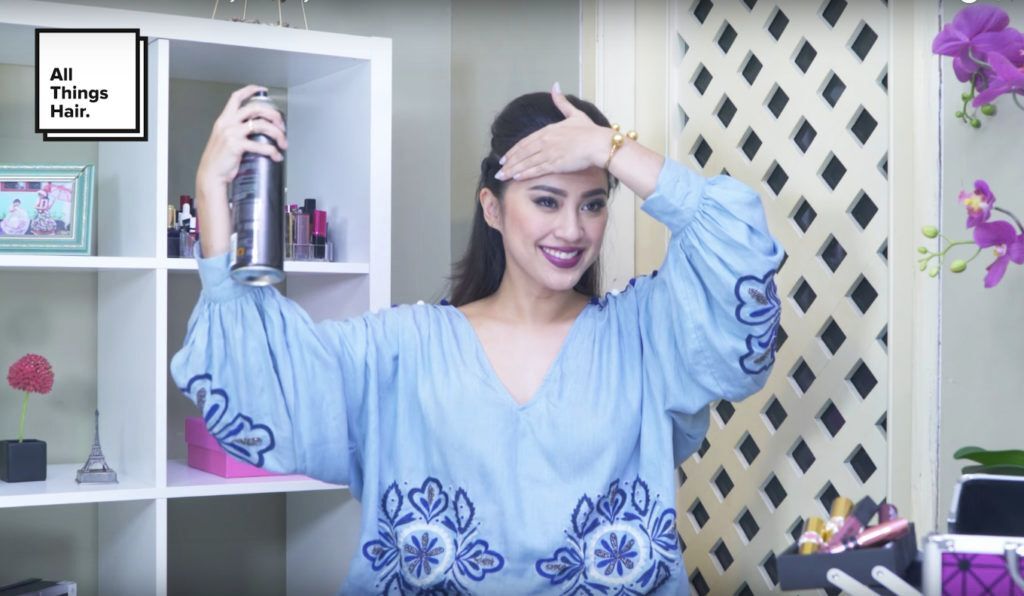 Menyemprotkan hair spray - model rambut festive bold twisted hairstyle
