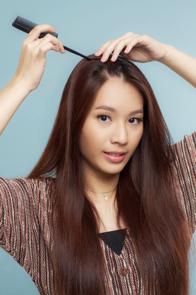 Wanita asia dengan model rambut french braid samping membelah rambut
