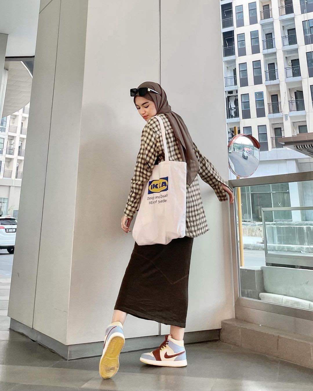 Atasan flanel dipadukan dengan rok span untuk style kuliah hijab. (Foto: Instagram/adiva.selsa)