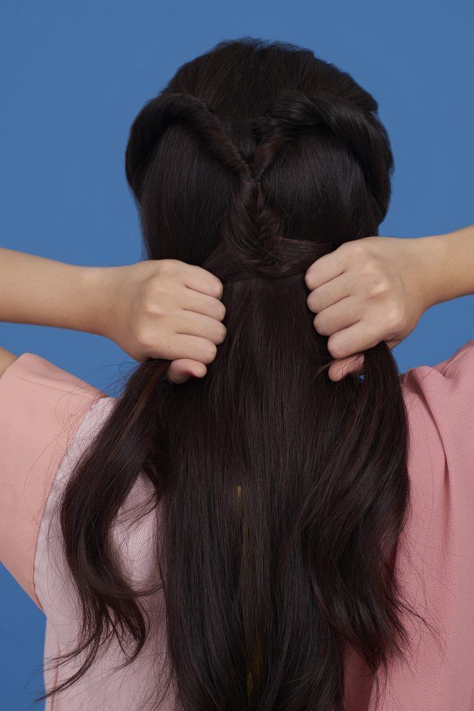 Wanita Asia sedang melakukan fishtail braid