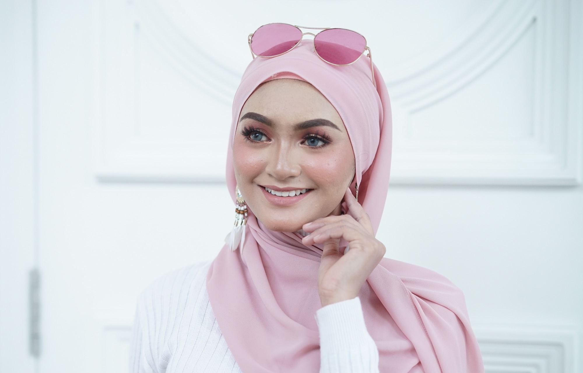 Wanita Asia memakai hijab warna pink