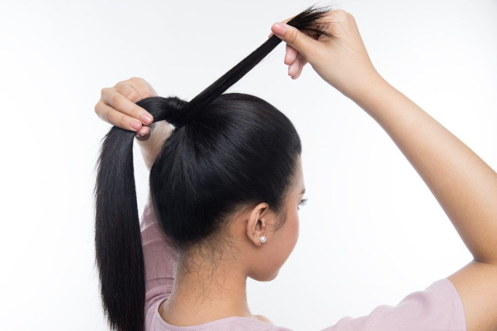 wanita asia sedang mengikat rambut