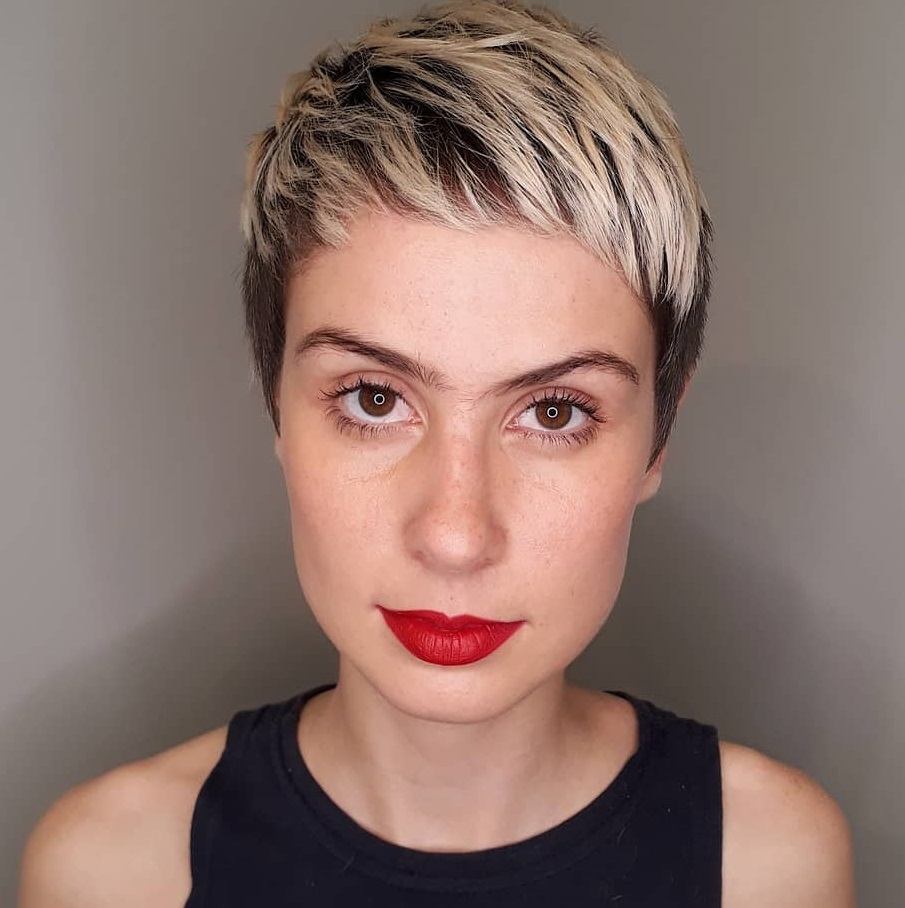 Wanita kaukasia dengan gaya rambut pixie cut dengan poni super pendek atau micro bangs.