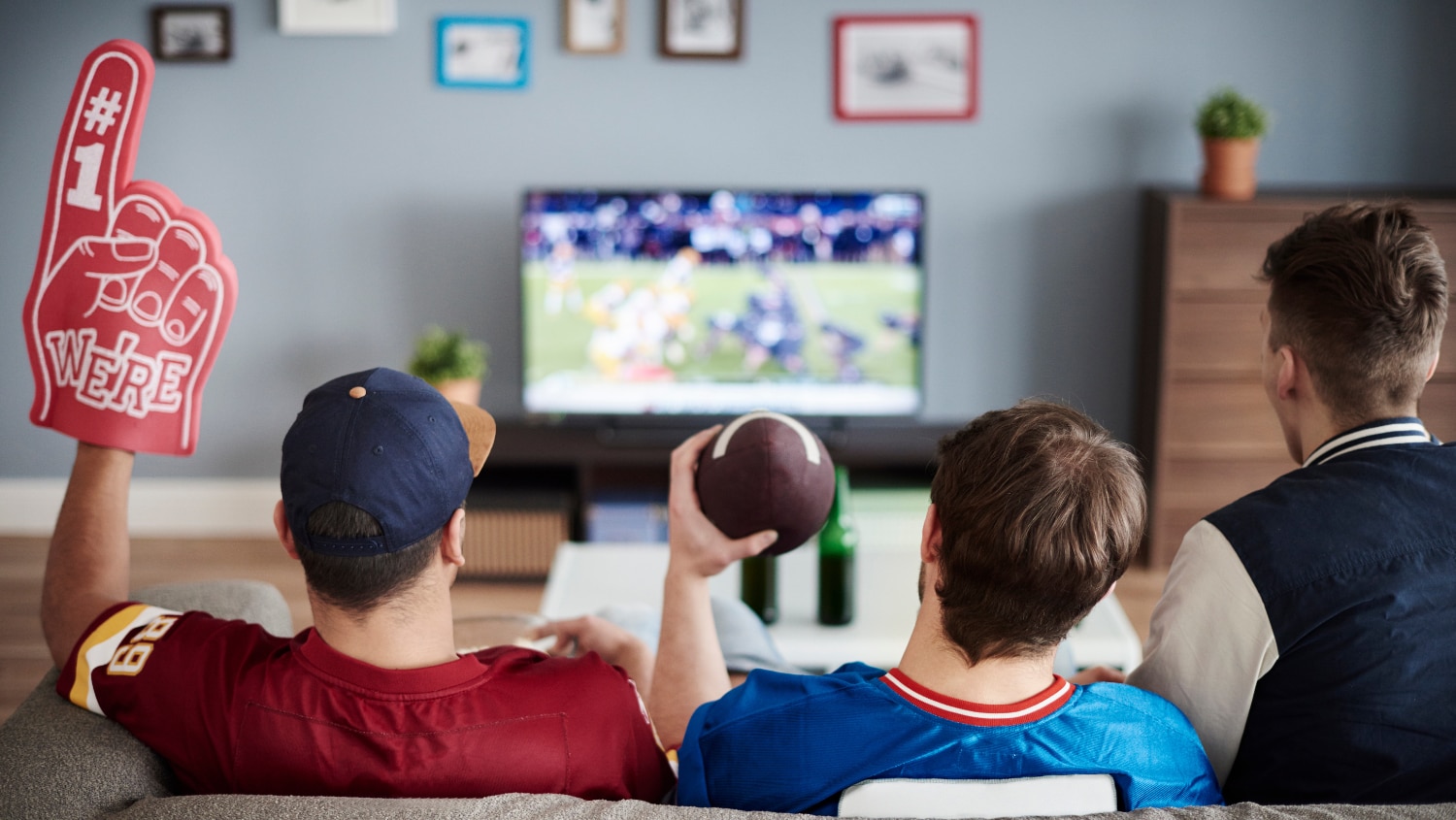 Group of friends watching the Superbowl together at a viewing party 