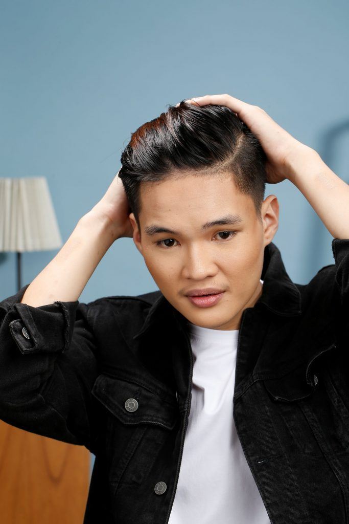 ผู้ชายเอเชีย ไว้ผมสั้นสีดำ กำลังเซ็ตผมทรงสลิคแบค