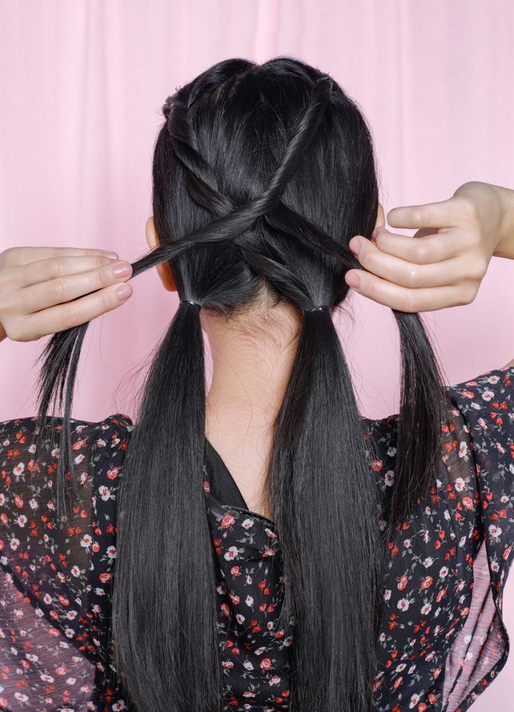 ผู้หญิงเอเชียผมยาวสีดำ กำลังพันเปียไขว้กัน