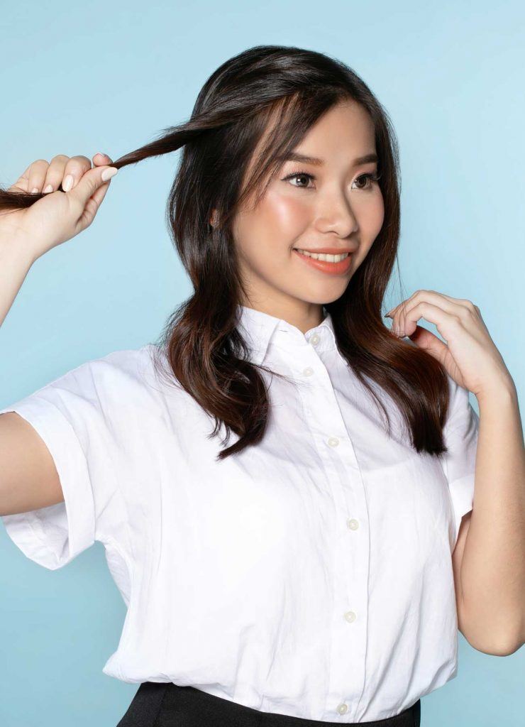 ผู้หญิงเอเชียผมยาว กำลังบิดเกลียวผม