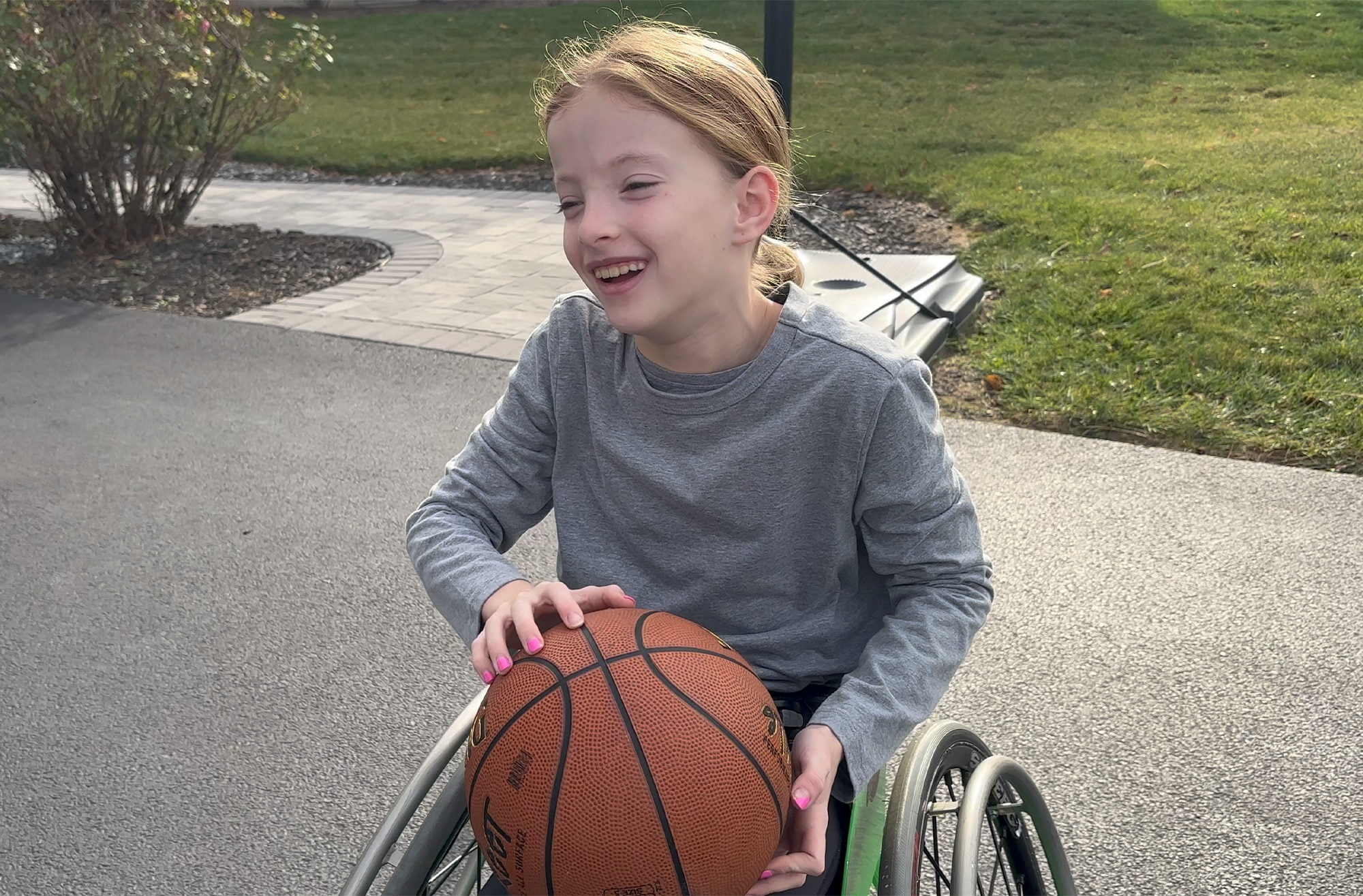 Dakota holding a basketball and smiling