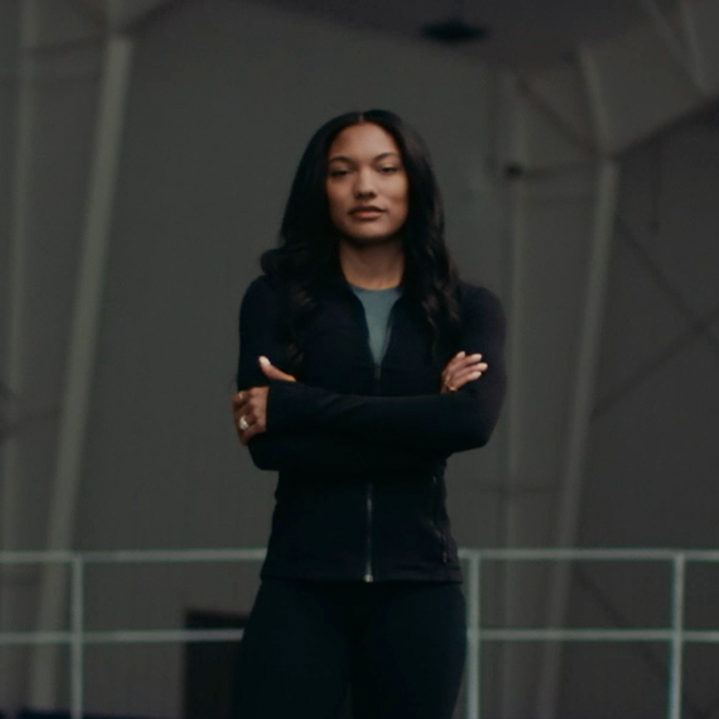 Tara Davis-Woodhall standing with her arms crossed