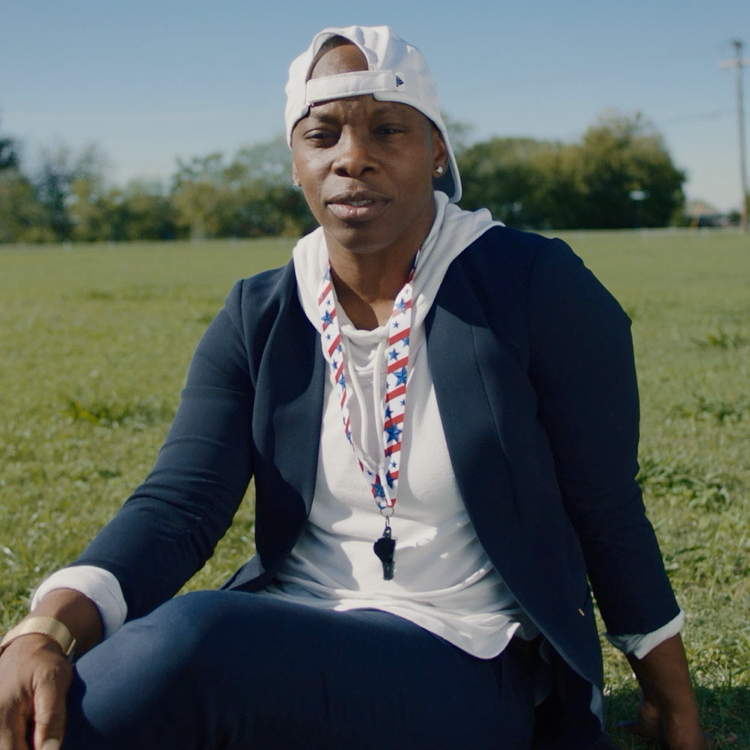 Odessa Jenkins sitting on a field 