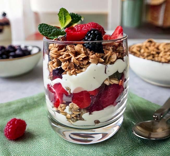 Vanilla berry ice cream parfait in a clear glass