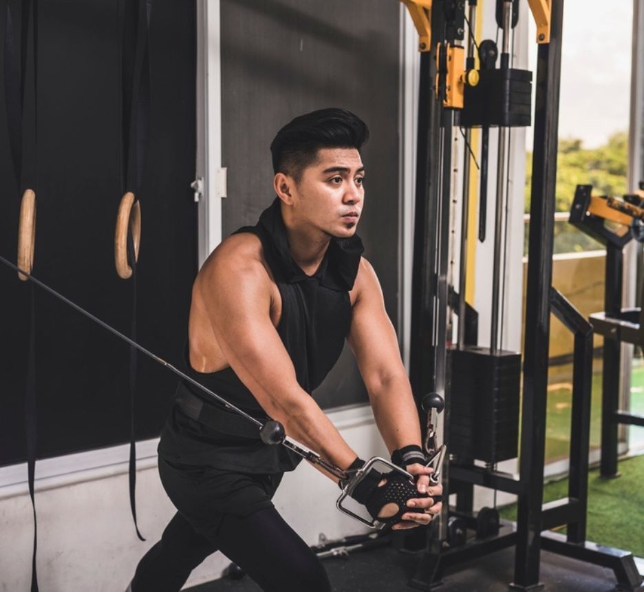 Man doing a set of cable crossovers at the gym.