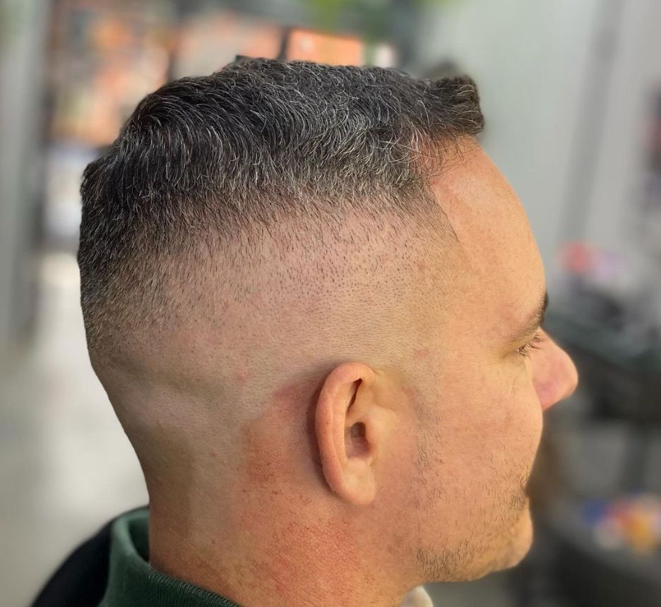 Man with high fade and buzz cut.