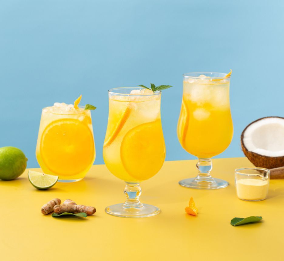 Fresh cocktails made of orange juice, coconut water, lime and ginger