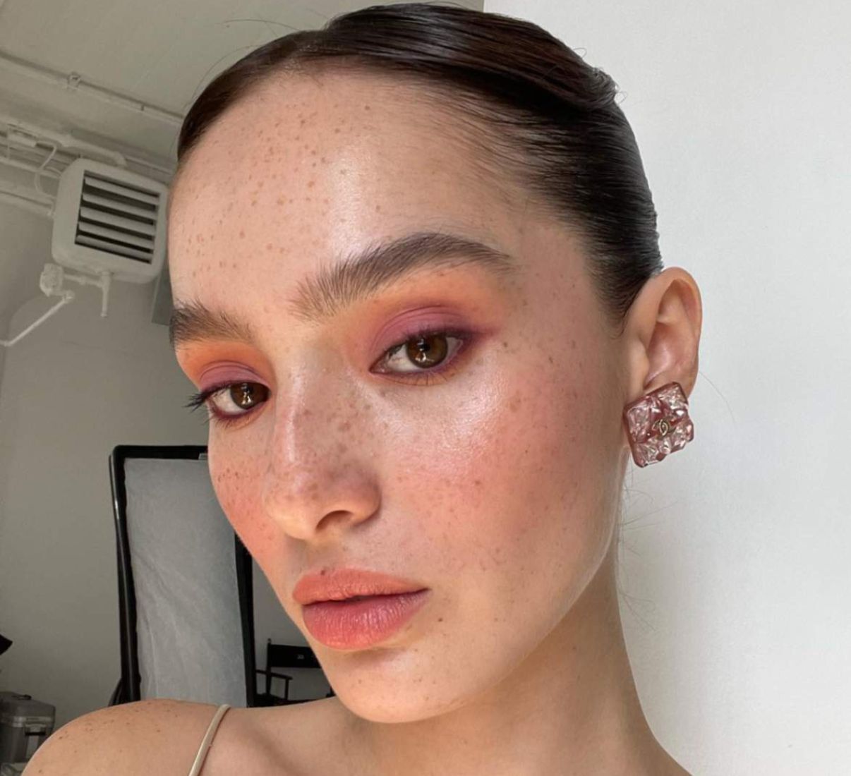 A Filipina model in a makeup look in sunset hues.