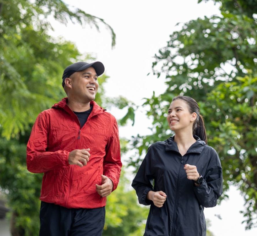 Man and woman talking while running together.