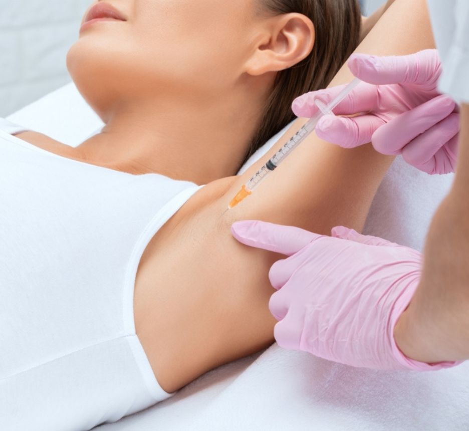 Woman getting Botox injection on her underarm.