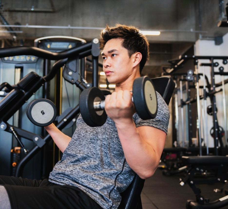 Man wiping his sweat after a workout.