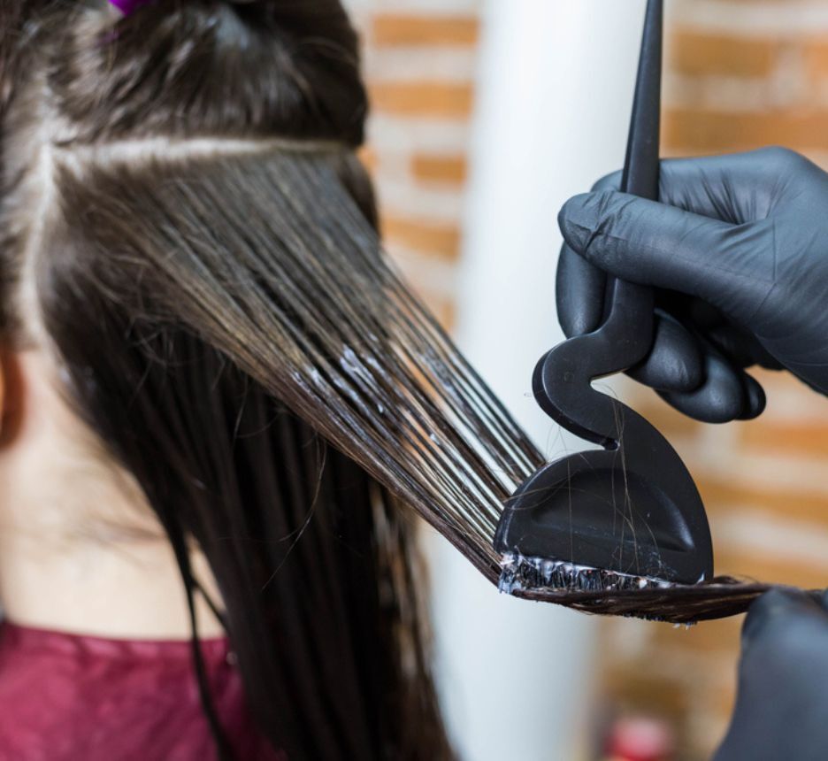 Woman getting a keratin treatment at a salon.