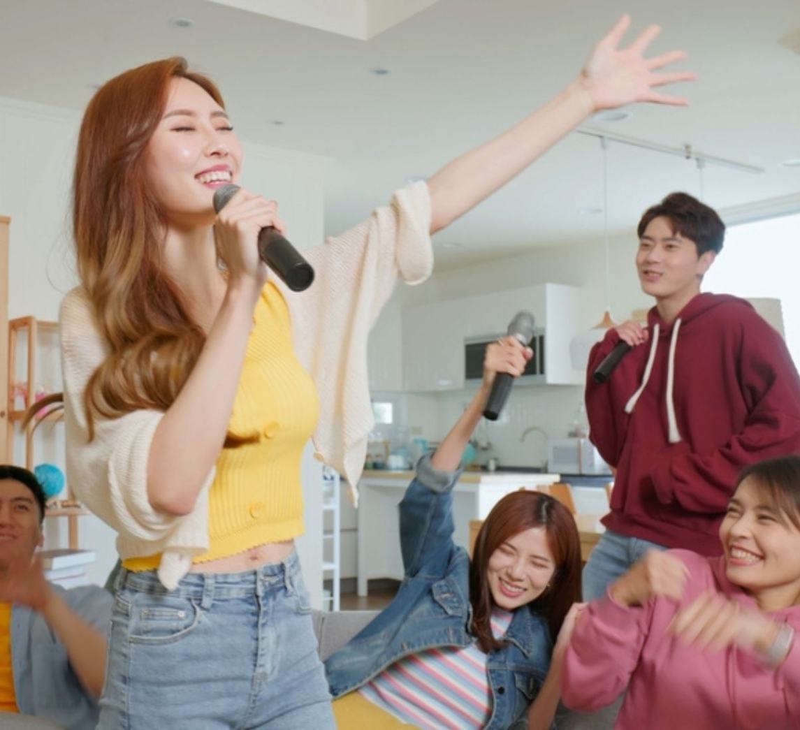 Asians having karaoke party at home.