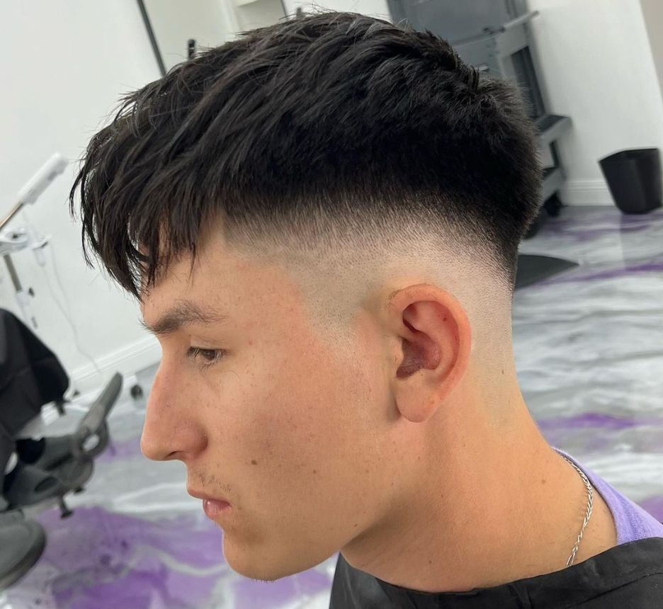 Man with mid fade and French crop.