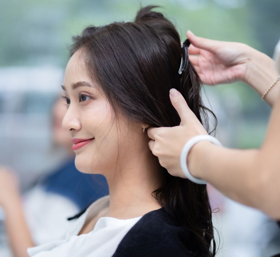 Woman with long hair getting a salon treatment.