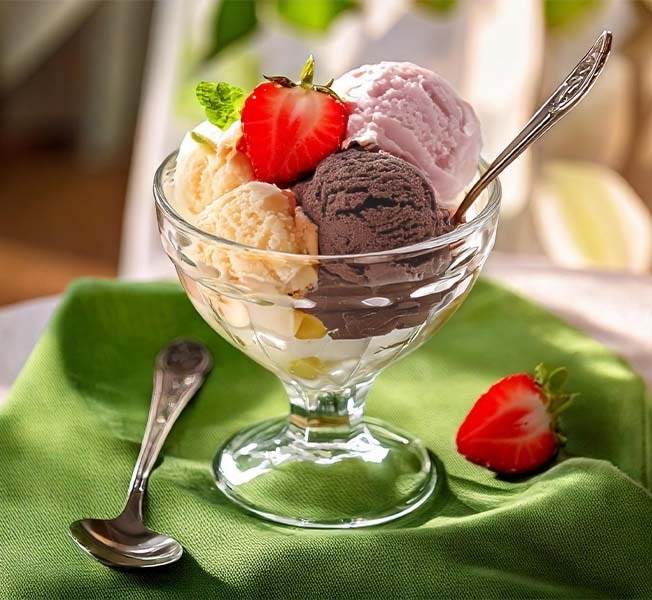 Scoops of Breyers Vanilla Chocolate Strawberry in a dessert cup