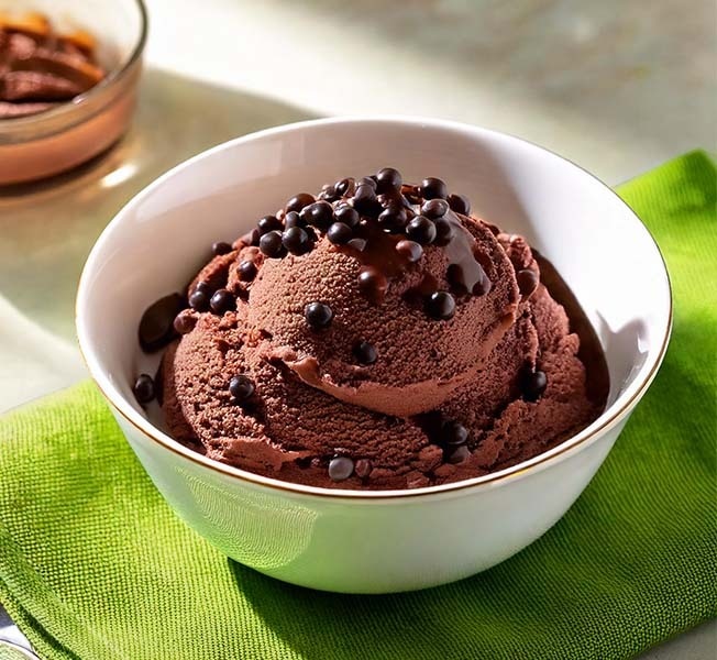 Scoops of chocolate boba ice cream in a bowl topped with tapioca pearls