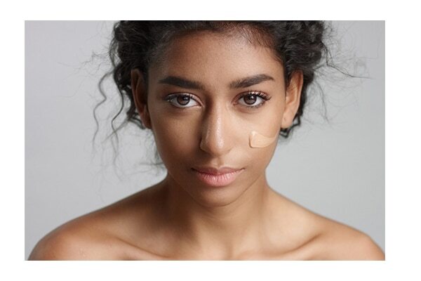 Dab loose powder before applying a concealer