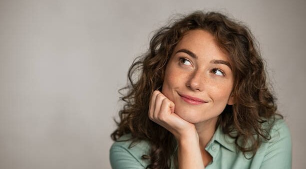 led face mask brunette woman brown curly hair