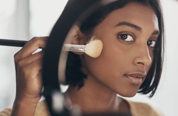 Concealer or Foundation? What is the Difference? woman dark skin brush