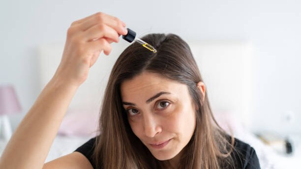 Top Benefits to Using Hair Oil for Hair Growth This Summer woman long brown hair