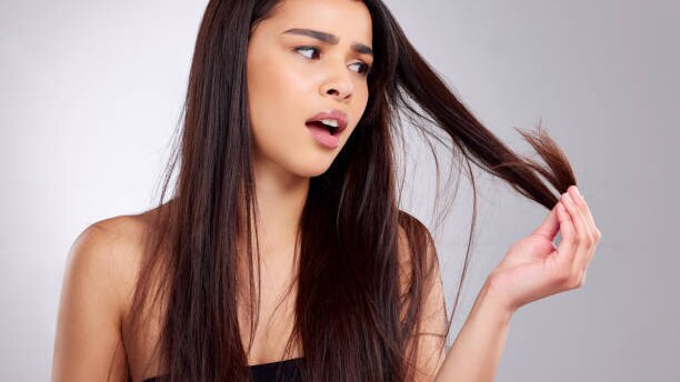 Top Benefits to Using Hair Oil for Hair Growth This Summer woman long brown hair