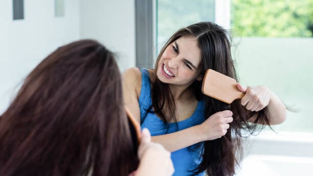 Top Benefits to Using Hair Oil for Hair Growth This Summer woman long brown hair