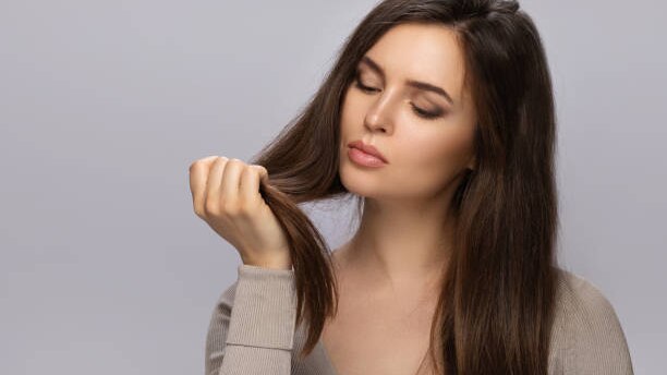 Top Benefits to Using Hair Oil for Hair Growth This Summer woman long brown hair