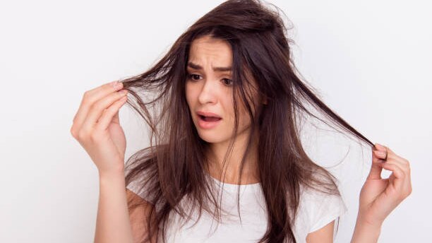 Top Benefits to Using Hair Oil for Hair Growth This Summer woman long brown hair